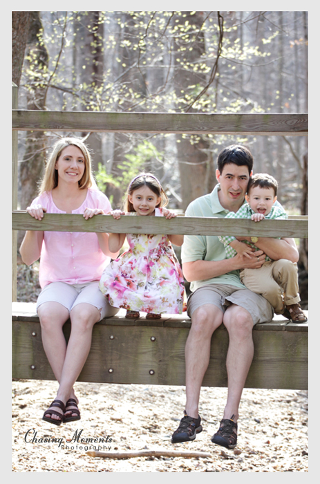 Parents and Children sitting on a bridge, outdoor park family portrait photography