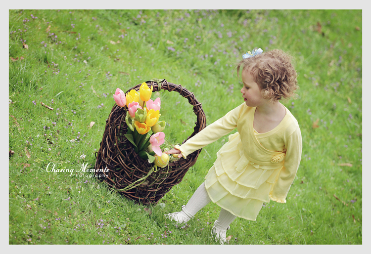 Little girl in a yellow Easter, spring outfit with a wicker basket in a park in McLean, VA