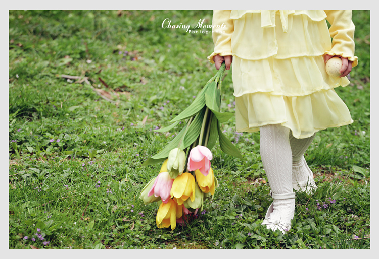 Girl in a yellow Easter outfit with tulip flowers