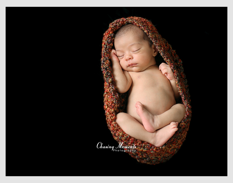 newborn asleep in a knit wrap