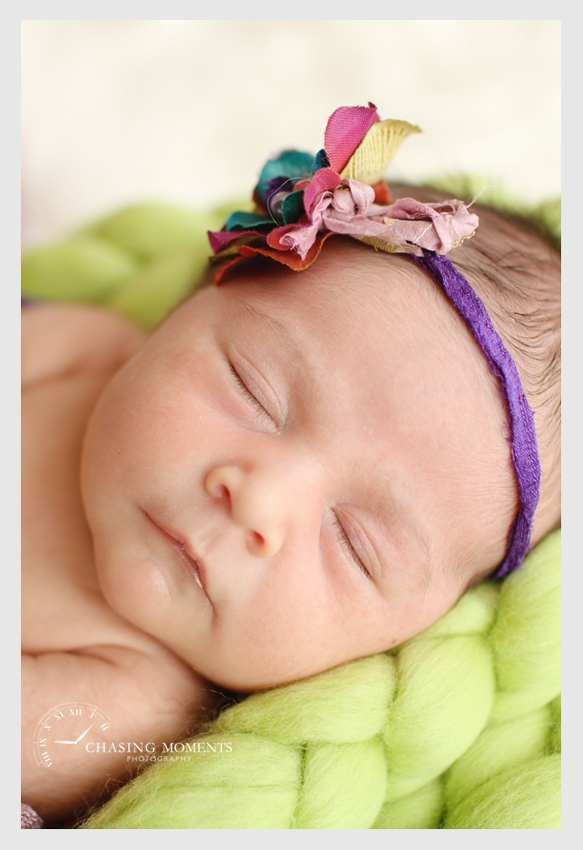 newborn baby girl asleep with headband