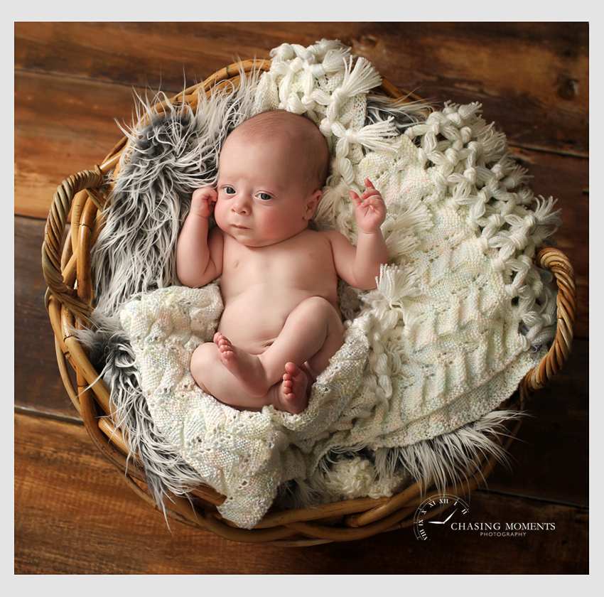 newborn baby boy on blankets in a basket