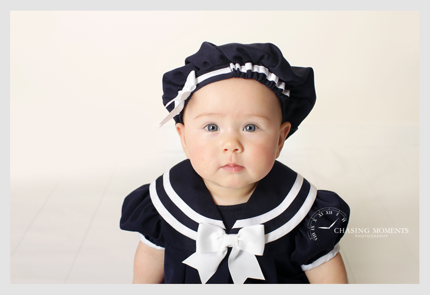 baby girl in navy outfit professional photographer